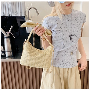 Close-up of woven straw bag with beige V-pattern and decorative bow detail