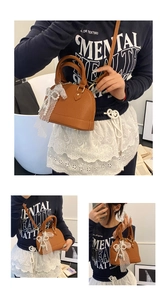 Detail of caramel leather shell bag with white lace bow and pearl chain accessories