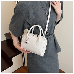White litchi pattern bowling bag detail with silver dolphin charm and shoulder strap