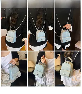 Multiple views of light blue tweed mini backpack with silver chain and twist lock