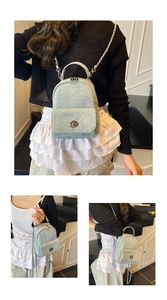 Detail of light blue denim mini bag showing metallic twist lock and chain strap details
