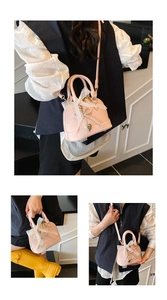 Detail of pink shell bag with lace bow, pearl charm, and silver heart pendant