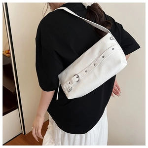 Close-up of white underarm bag featuring silver buckle and subtle leather texture