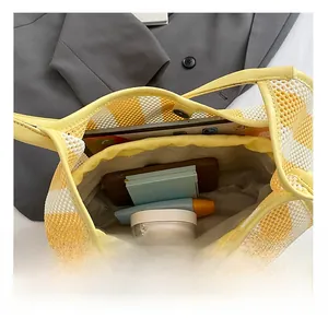 Interior view of striped mesh tote bag showing large capacity for tablet and cosmetics