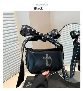 Gothic black leather shoulder bag with silver cross charm and studded bow handle detail