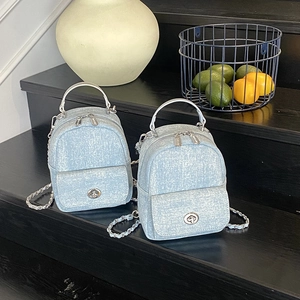 Light blue denim texture mini backpack with silver metal handle and chain strap for women