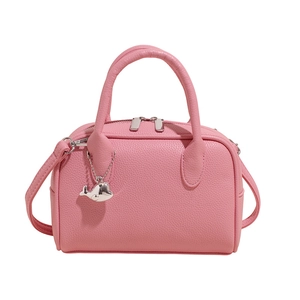 Pink lychee textured Boston bag with silver whale charm and dual zipper closure