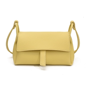 Minimalist yellow lychee grain leather crossbody pillow bag with refined white stitching