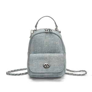 Mini light blue denim backpack with silver metal chain strap and turn-lock closure