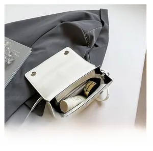 Internal view of a white leather crossbody bag showing spacious capacity for essentials