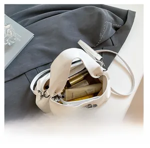 Spacious interior of white lychee pattern crossbody bag showing storage capacity