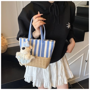 Blue and white striped canvas tote with straw bottom and cute teddy bear charm