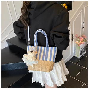 Blue and white striped beach tote with bear charm shown styled on a model