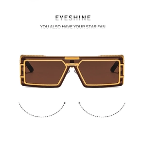 Détail de lunettes de soleil géométriques en métal doré avec verres dégradés bruns