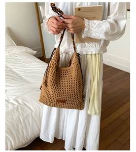 Detailed close-up of brown crochet tote bag featuring wooden bead shoulder strap detail