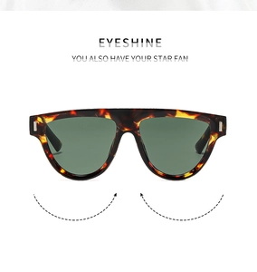 Detail of tortoise frame sunglasses with green lenses and metal hinge accents