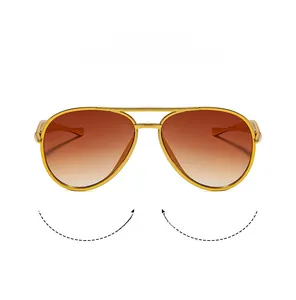 Close-up of golden double-bridge metal frame and red gradient lenses of aviator sunglasses