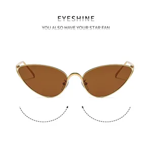 Close-up of cat-eye sunglasses with gold metal frame and brown polarized lenses