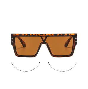Detail of tortoise frame sunglasses with orange lenses and metal rivet accents
