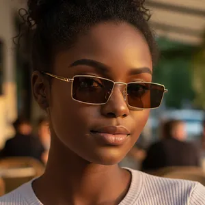 Retro rectangle sunglasses with gold metal frame and dark lenses on female model