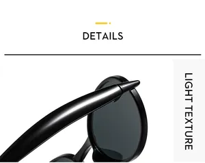 Détail des lunettes de soleil ovales noires brillantes montrant la texture légère du cadre