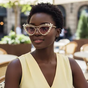 Close-up of luxury cat-eye sunglasses with hand-set pearls and rhinestones decoration