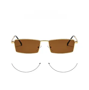 Detail of vintage gold rectangular metal sunglasses with brown lenses and adjustable nose pads