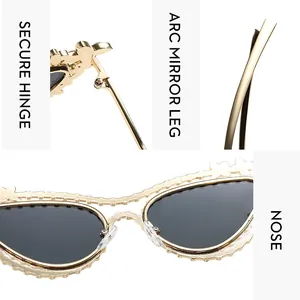 Detail of luxury rhinestone butterfly sunglasses with gold wavy frame and dark lenses