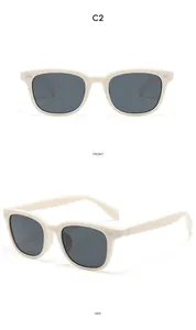 Détail de lunettes de soleil carrées crème avec accents métalliques et verres gris