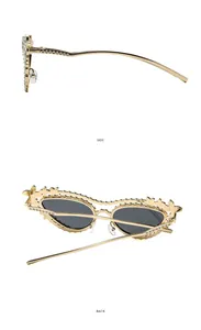 Detail of luxury rhinestone sunglasses featuring intricate gold floral filigree and side view