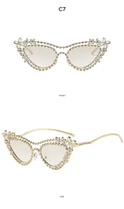 Detail of luxury gold metal butterfly frame sunglasses with dense rhinestone flowers