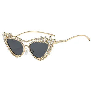 Luxury cat-eye sunglasses with rhinestone-encrusted gold frames and dark grey lenses