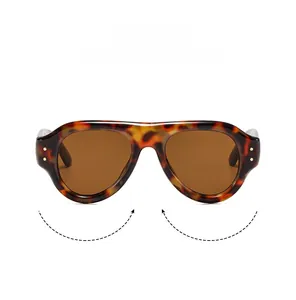 Macro shot of tortoiseshell sunglasses frame featuring vintage oval shape and metal dot details