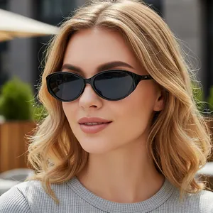 Classic oval black frame sunglasses with dark lenses for women in outdoor street style