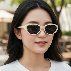 Retro cream white oval sunglasses for women with dark grey lenses in outdoor setting