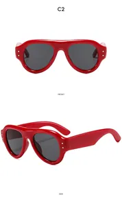 Front and side view of vintage red oval sunglasses with metal studs and dark lenses