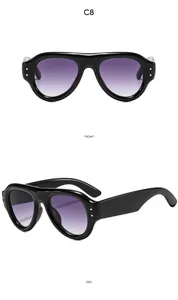 Front and side views of vintage oval sunglasses with black frame and golden rivets