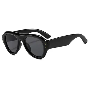 Retro oval black sunglasses with thick frames and gold dot accents on white background