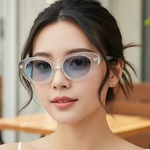 Modern transparent cat-eye sunglasses with blue gradient lenses and gold metal accents