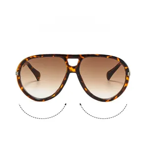 Macro detail of tortoiseshell pilot sunglasses featuring model M9283 and brown gradient lenses