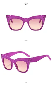 Detail view of purple cat-eye sunglasses with orange-pink gradient lenses and textured arms