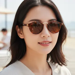 Y2K style retro tortoiseshell cat eye sunglasses with brown lenses worn by female model