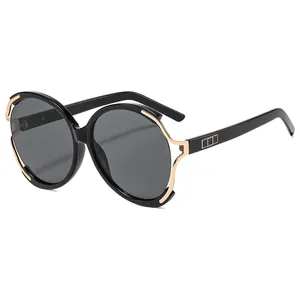 Lunettes de soleil rondes oversize modernes avec monture dorée et verres polarisés