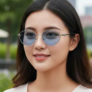 Oval silver metal sunglasses with blue gradient lenses on model for outdoor fashion