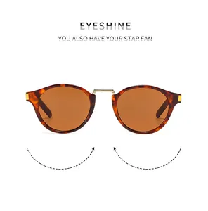 Close-up of tortoise shell frames and orange lenses on vintage round sunglasses