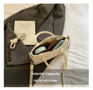 Internal capacity of the off-white textured crossbody bag showing daily essentials