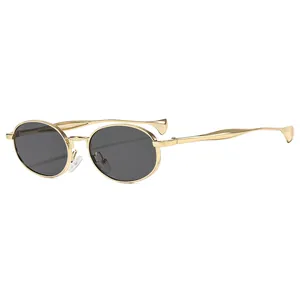 Chic oval sunglasses with golden metal frames and wavy temples shown from 45-degree angle