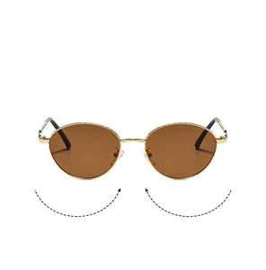 Detail of retro oval sunglasses featuring a gold metal frame and brown tinted lenses