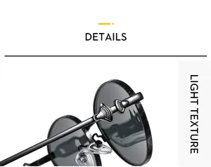 Detail of metal hinge with embossed relief decoration on vintage oval sunglasses