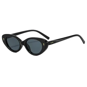 Retro cat-eye sunglasses in shiny black with gold rivet accents and dark lenses